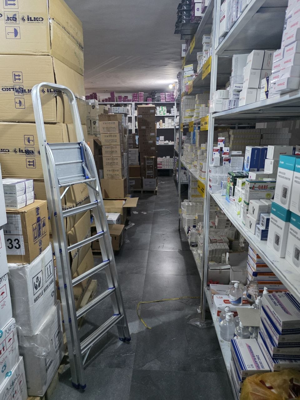 MayaMed Trading warehouse aisle stocked with pharmaceutical boxes and medical supplies